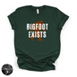 Bigfoot Exists Tee | Funny Cryptid Graphic T-Shirt (WHITE DESIGN)